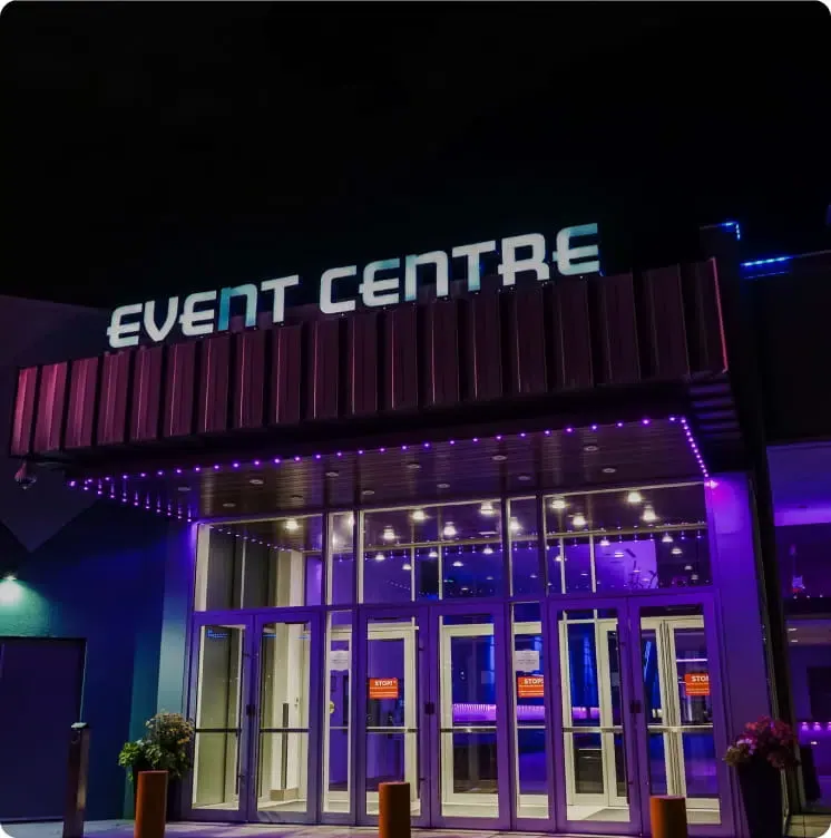 Event centre entrance at night with purple lights along the canopy