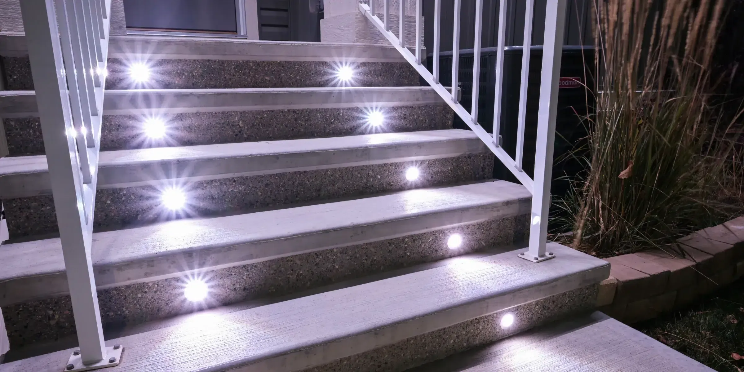 White concrete stairs with bright lights in each step