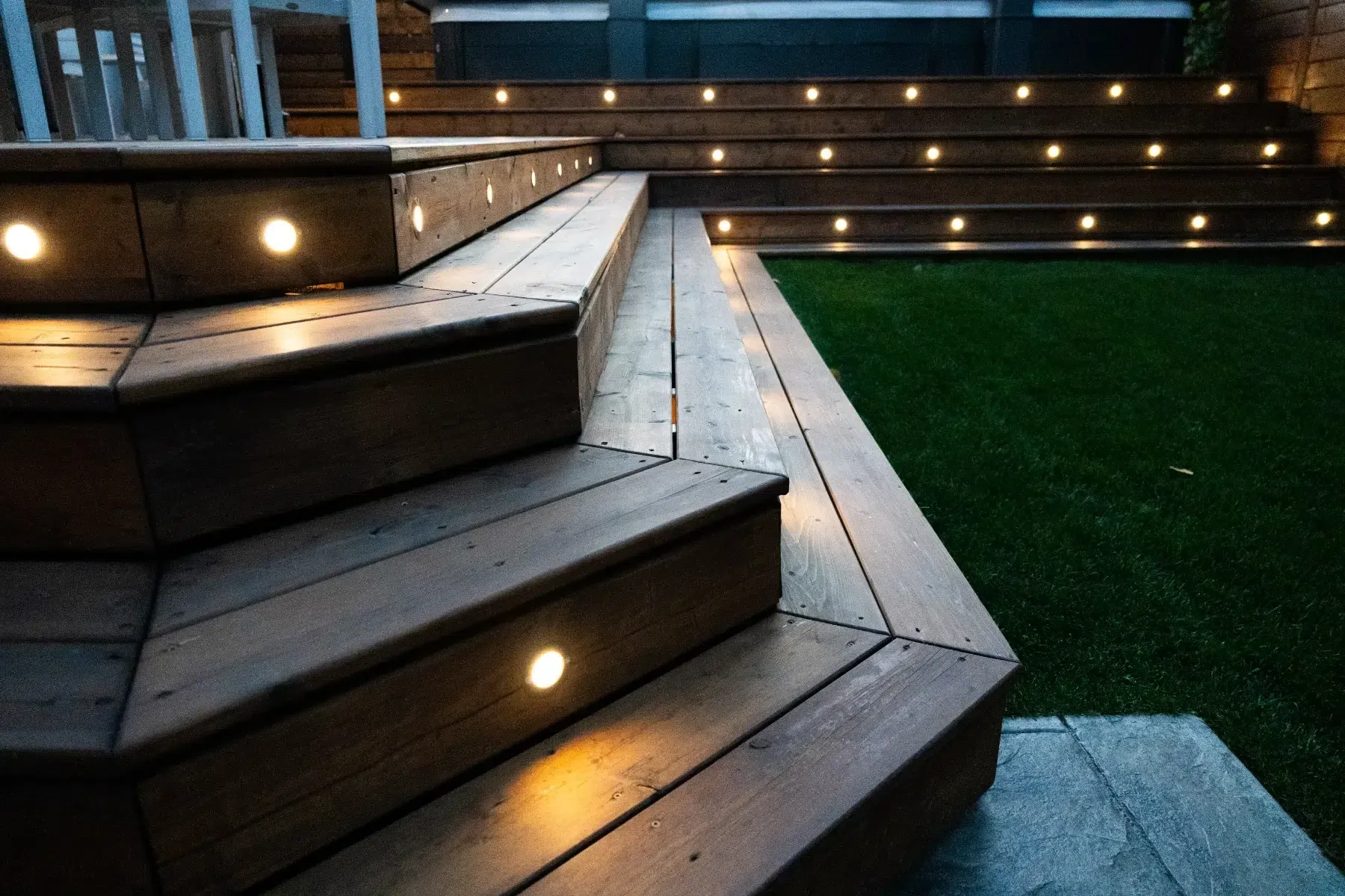 Close view of deck steps with small warm lights