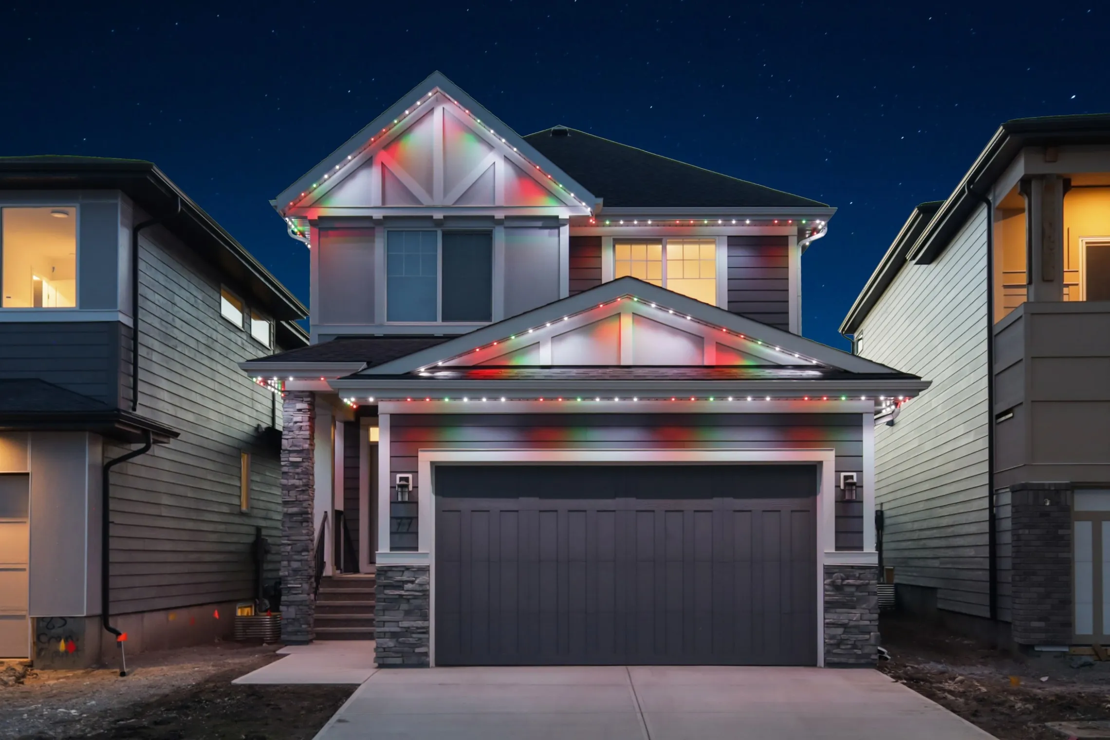 The same house in red, green and white Christmas lights