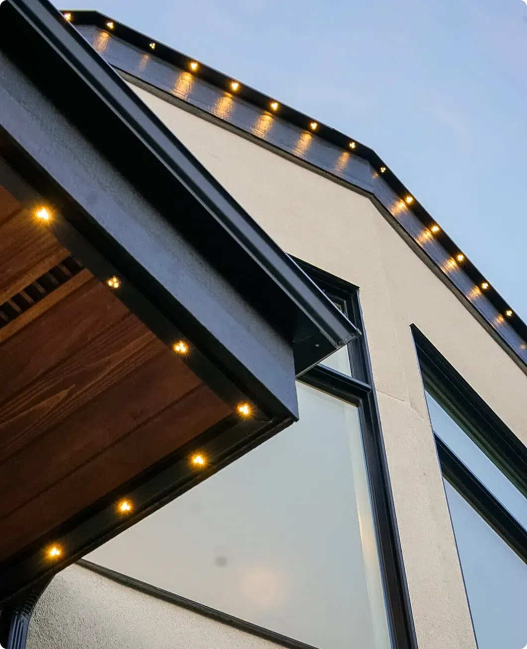 Close-up of warm lights in a dark track under the roof edge