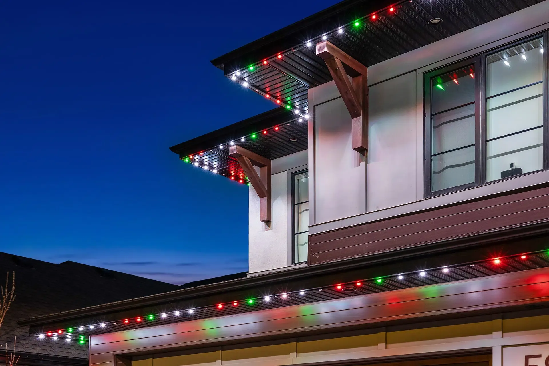 Close-up of a soffit with red, green and white lights in a slim track