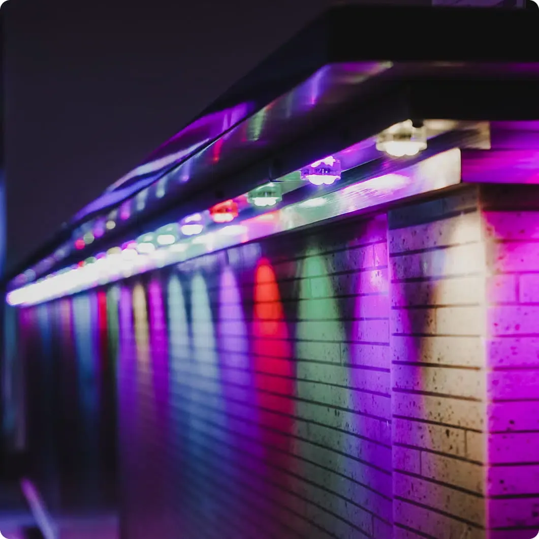 Indoor track lights in multicolour along a wall ledge