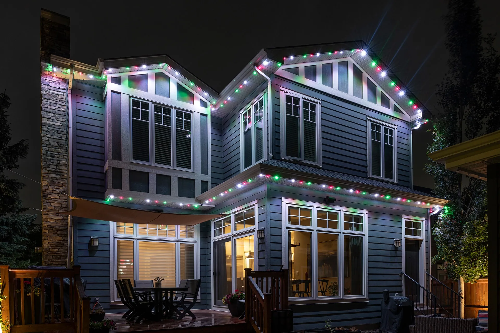 Craftsman house with red, green and white Christmas lights