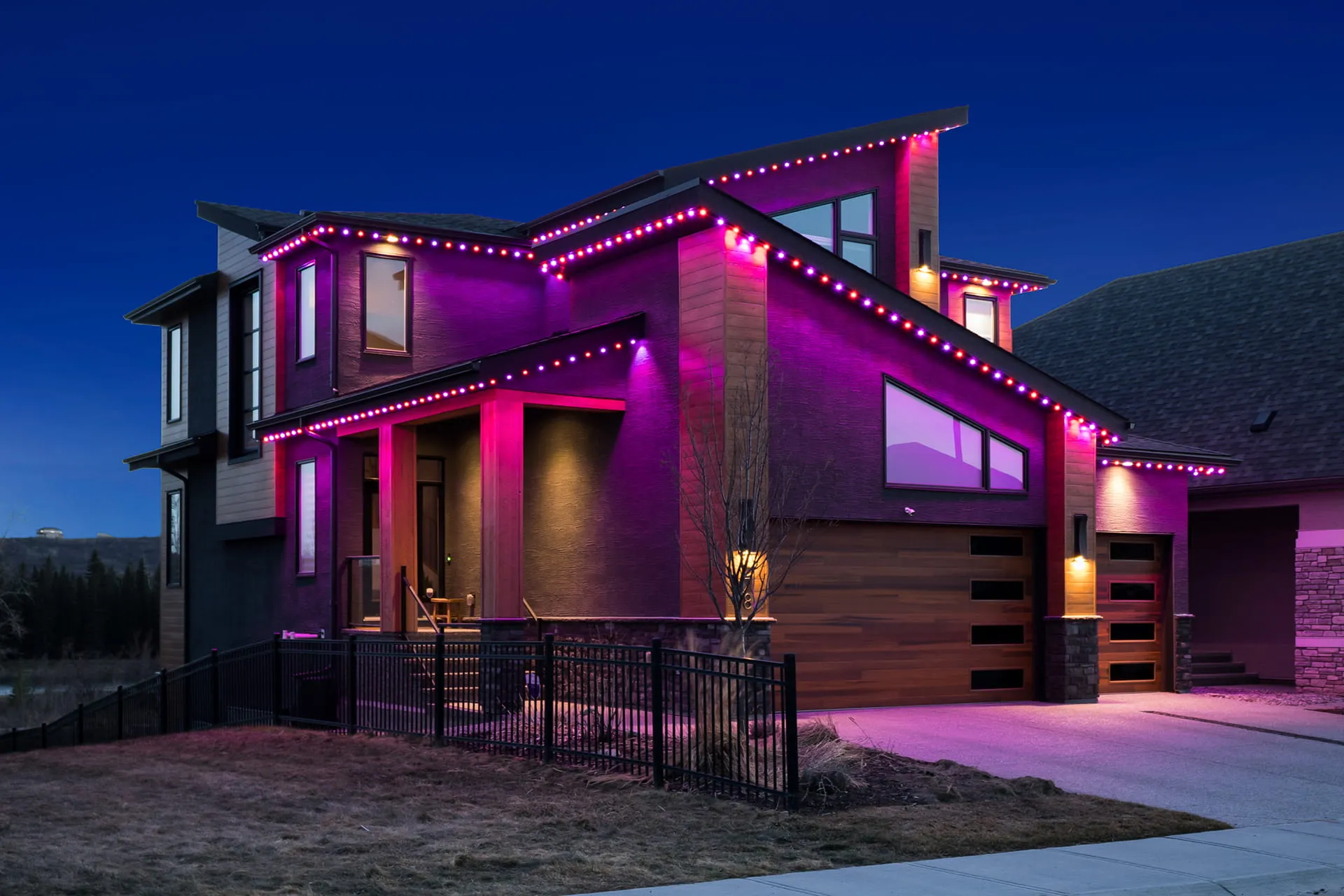 Modern house with pink and magenta roofline lights